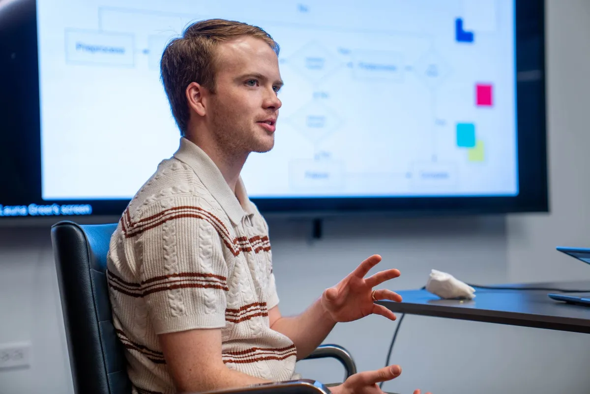Trevor Spreadbury presenting architecture slides to a room of software engineers